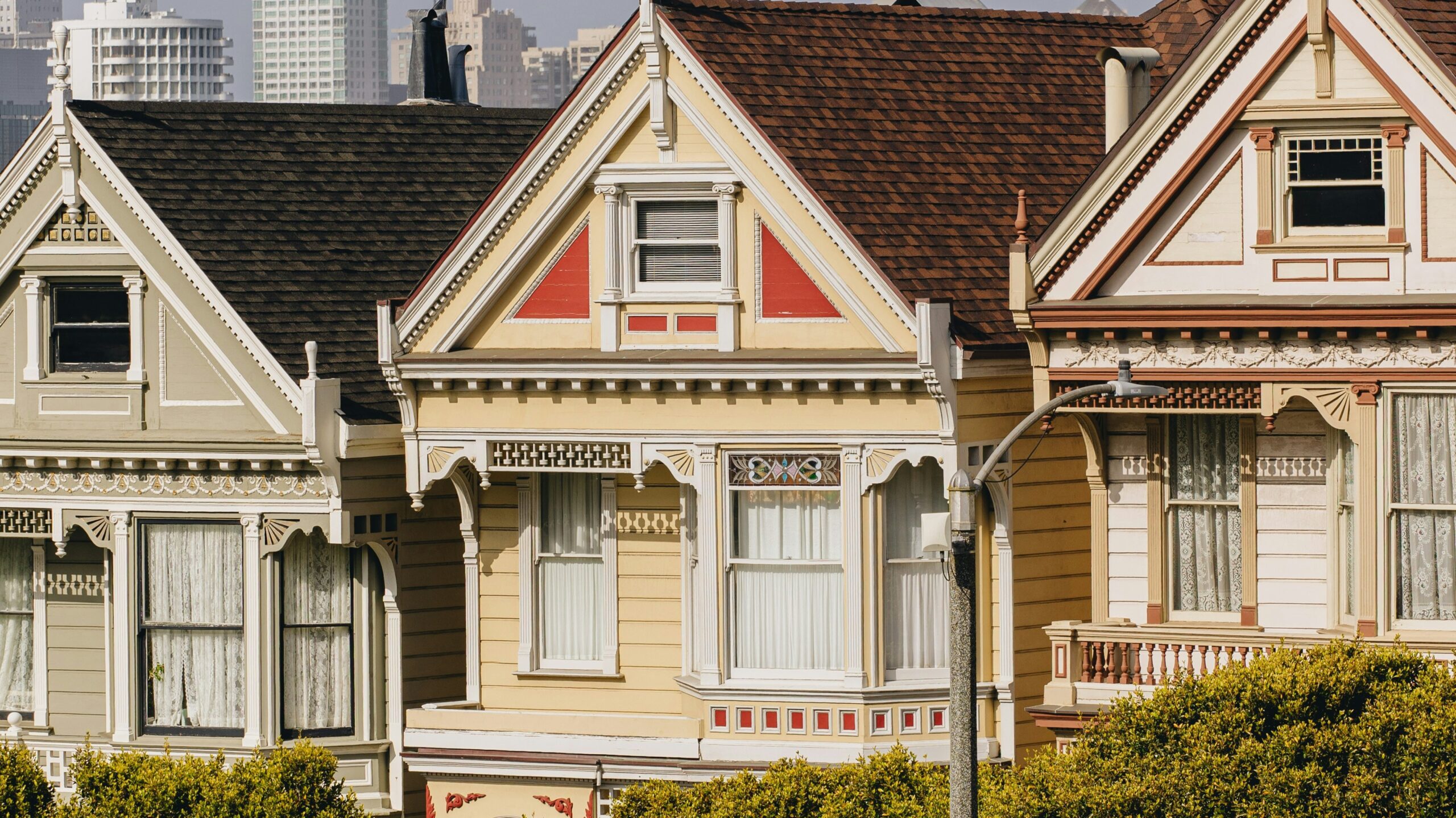 a row of houses with cars parked in front of them
