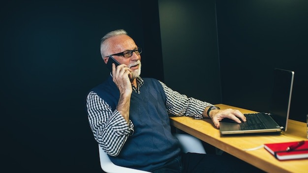 Senior man working in his office.