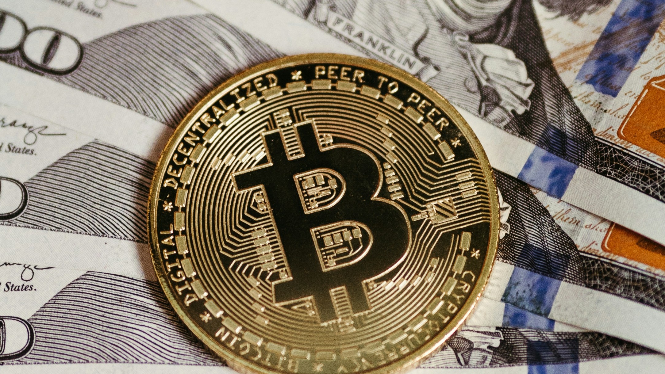 a bitcoin sitting on top of a pile of money