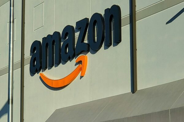 an amazon store with a person sitting in front of it