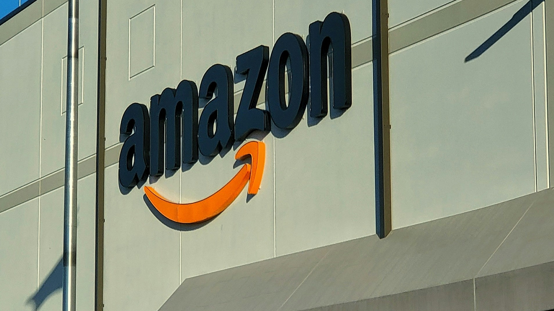 an amazon store with a person sitting in front of it