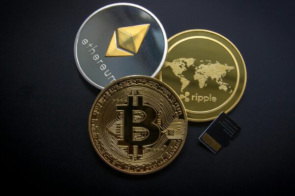 A striking image of Bitcoin, Ethereum, and Ripple coins illustrating modern digital currency.