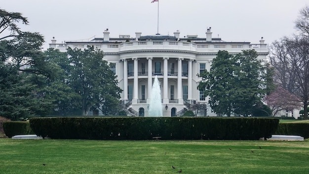 White house lawn and fountain in Washington, DC with gray sky