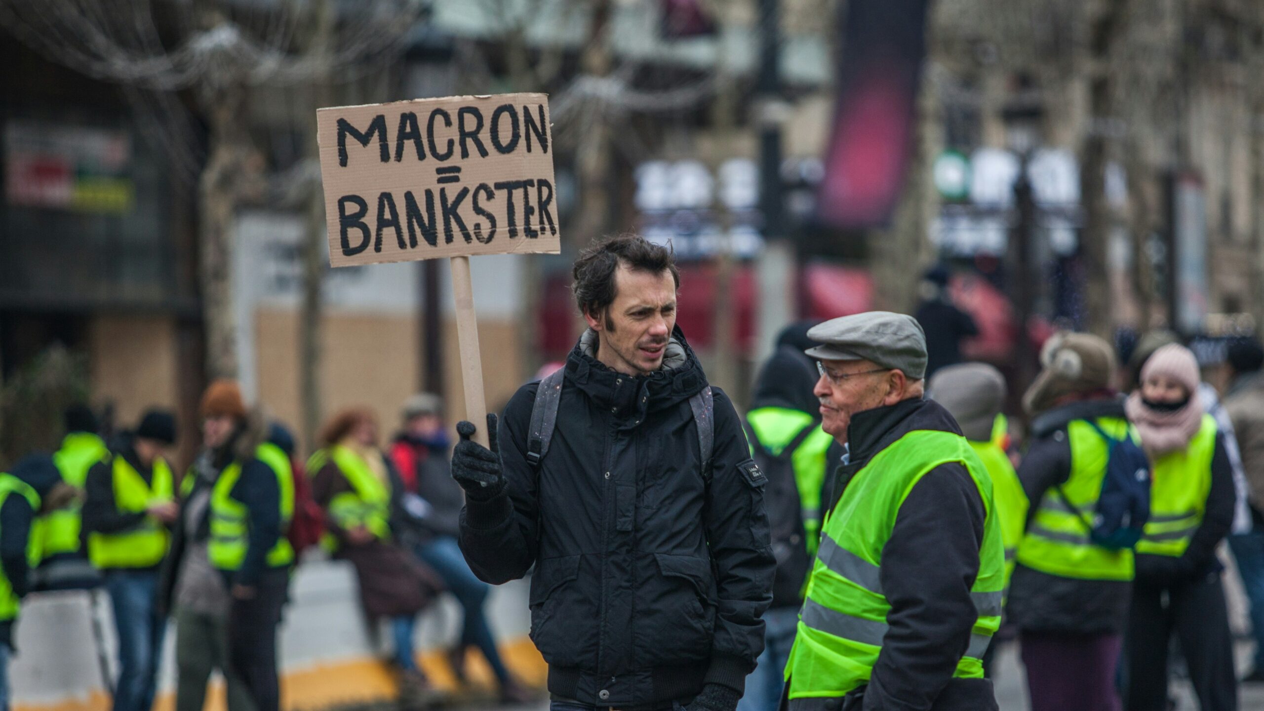 man holding gray signage