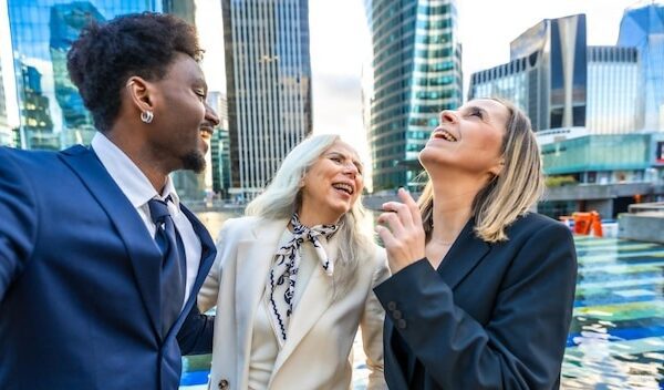 Diverse business team colleagues enjoying a laugh outdoors