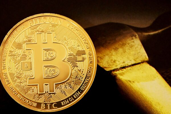 gold round coin on black surface