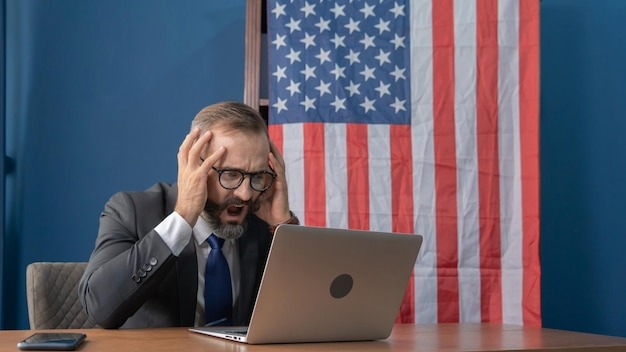 Mid adult man using mobile phone at table