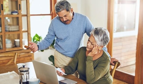 Finance stress and senior couple on laptop with bills paperwork and documents for life insurance Retirement pension and elderly man and woman with doubt for mortgage payment investment or budget