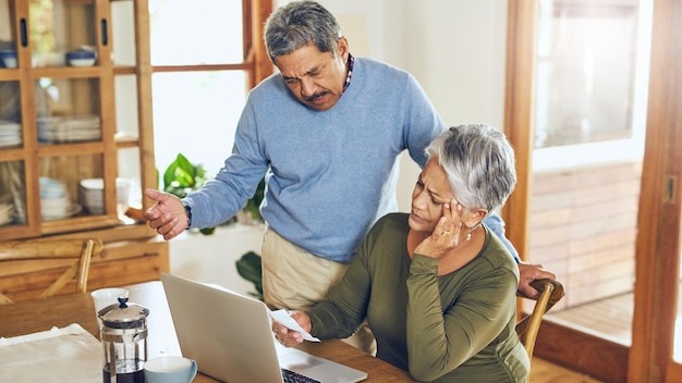 Finance stress and senior couple on laptop with bills paperwork and documents for life insurance Retirement pension and elderly man and woman with doubt for mortgage payment investment or budget