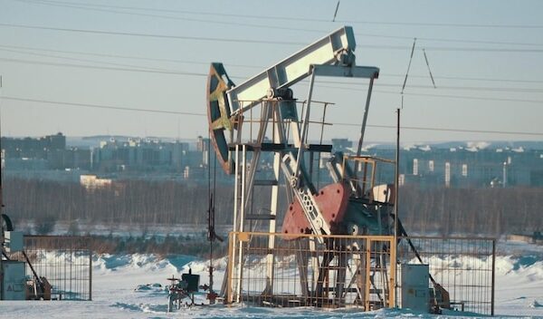 Operating unit for crude oil production against the background of the city, petroleum industry