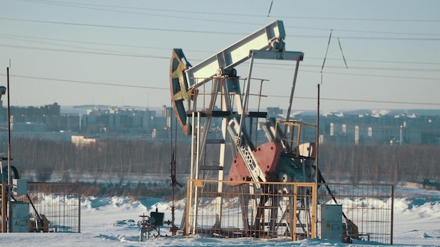 Operating unit for crude oil production against the background of the city, petroleum industry