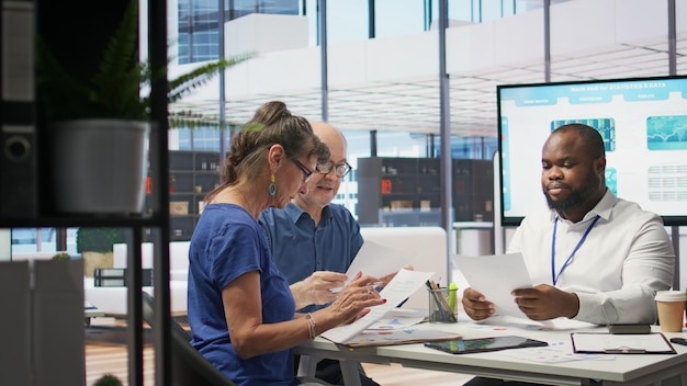 Financial adviser using calculator to create projection in securing savings
