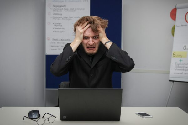 A man sitting in front of a laptop computer