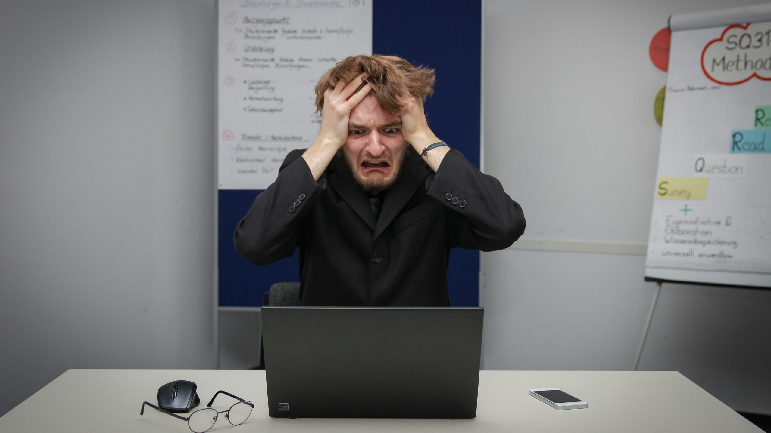 A man sitting in front of a laptop computer