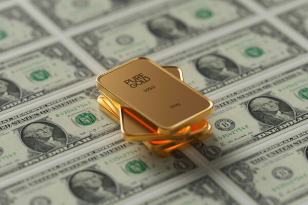 a gold bar sitting on top of a pile of money