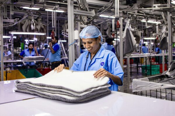 Workers are busy in an industrial clothing factory.