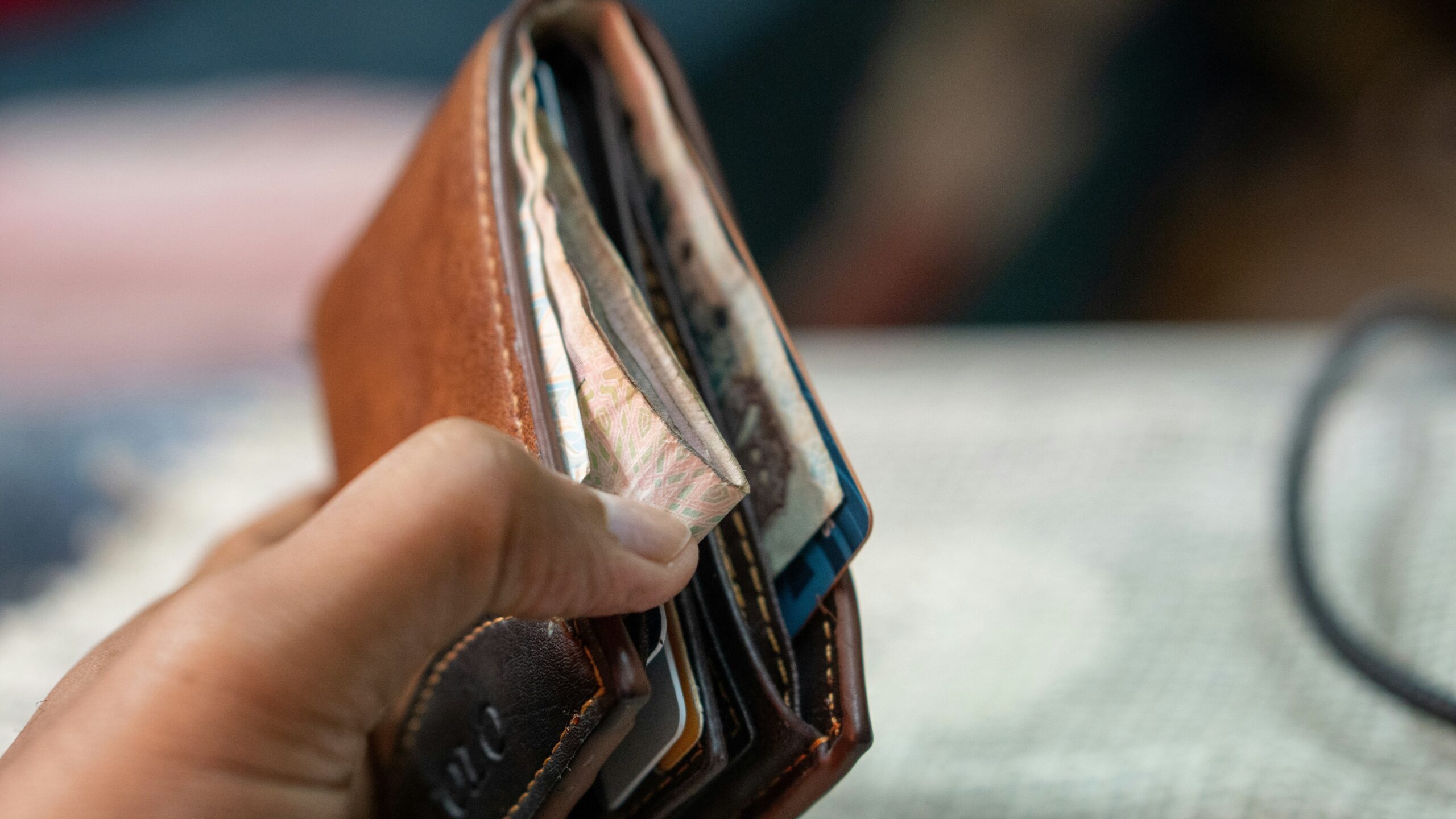 a person holding a wallet in their hand