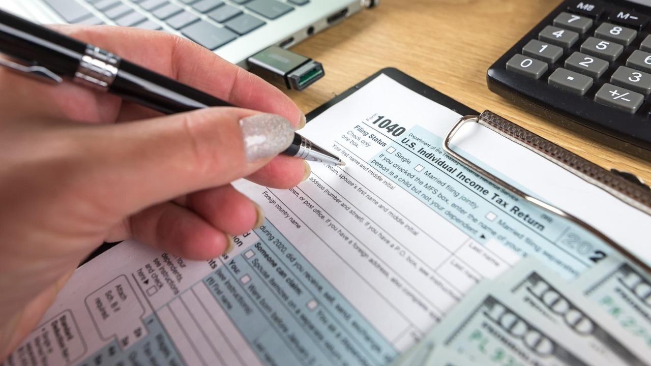 Tax form us business income office hand filling concept