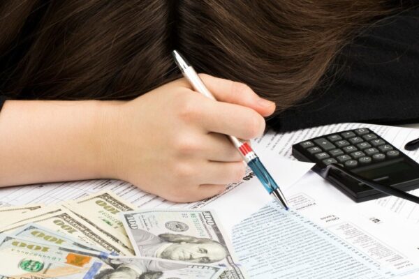 Woman sleeps on the individual Income Tax Return.