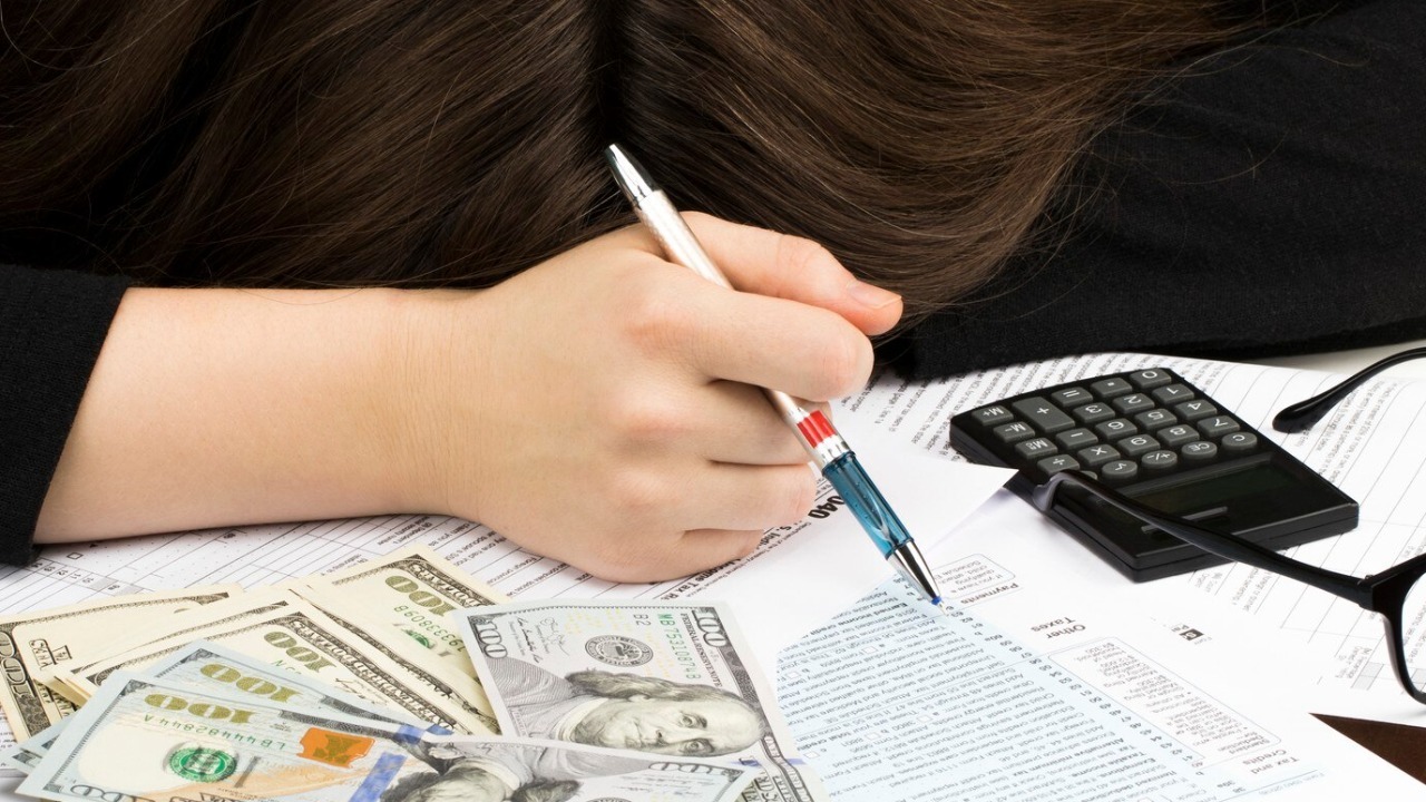 Woman sleeps on the individual Income Tax Return.