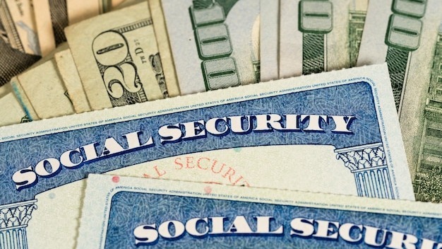 USA Social security cards laid on dollar bills