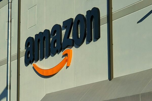 an amazon store with a person sitting in front of it