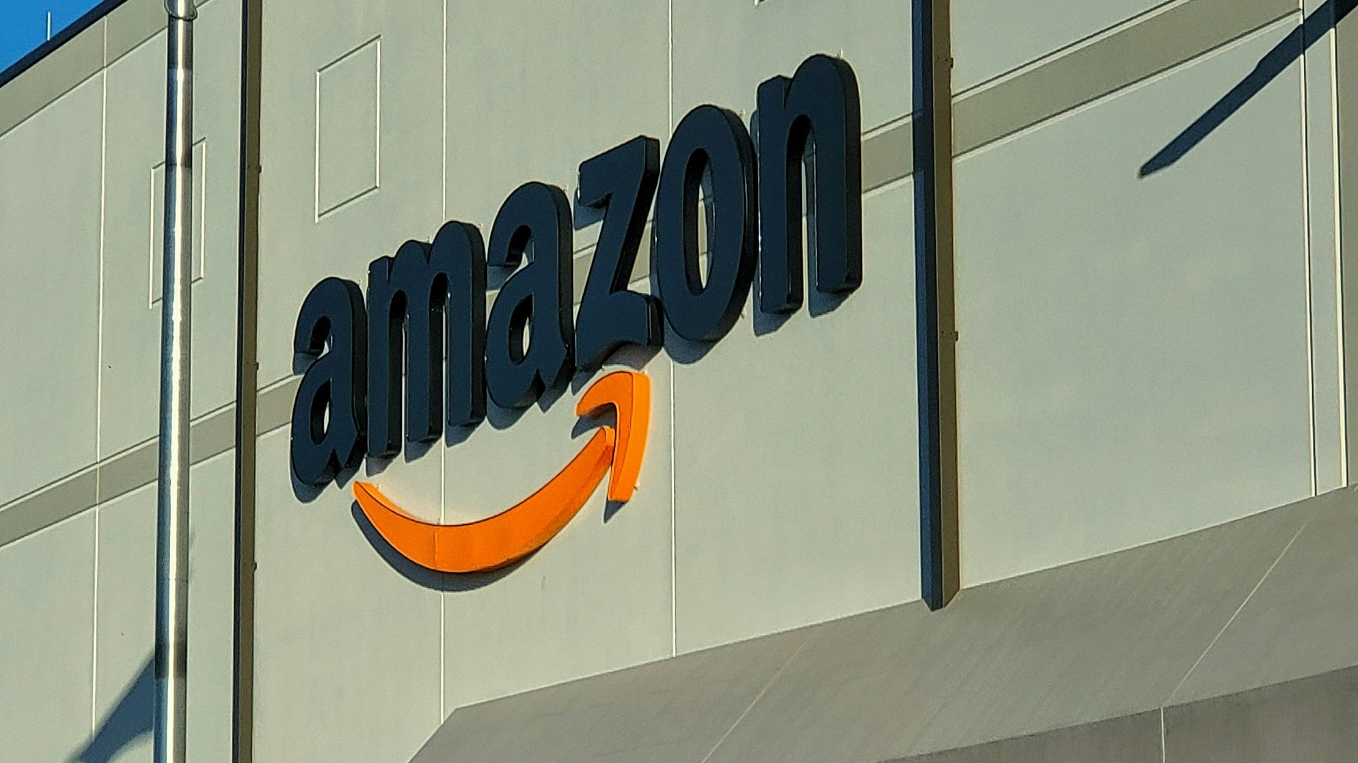 an amazon store with a person sitting in front of it