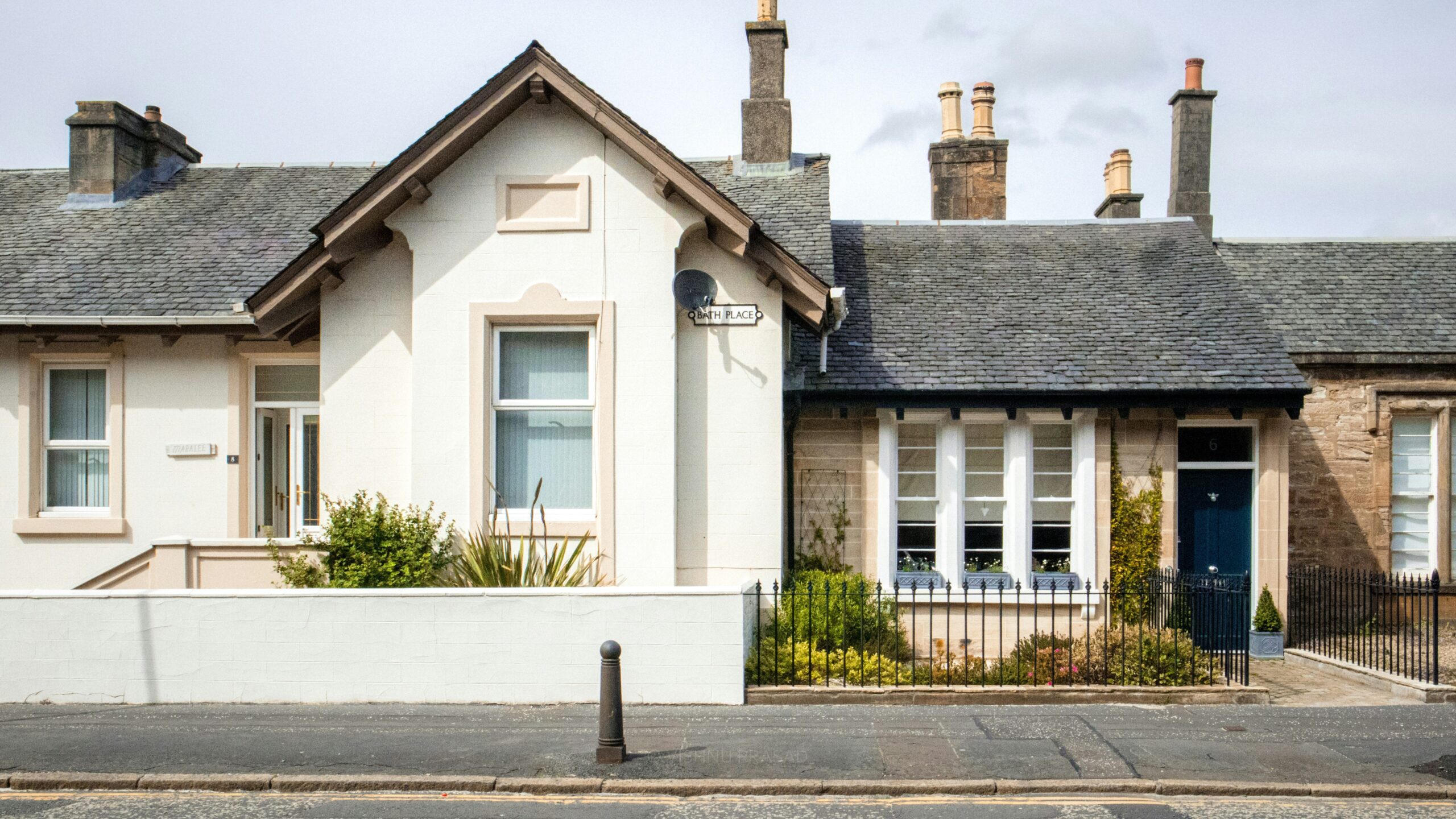 a white house with a blue door and windows
