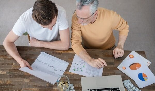 Two men working together on a project and looking concentrated