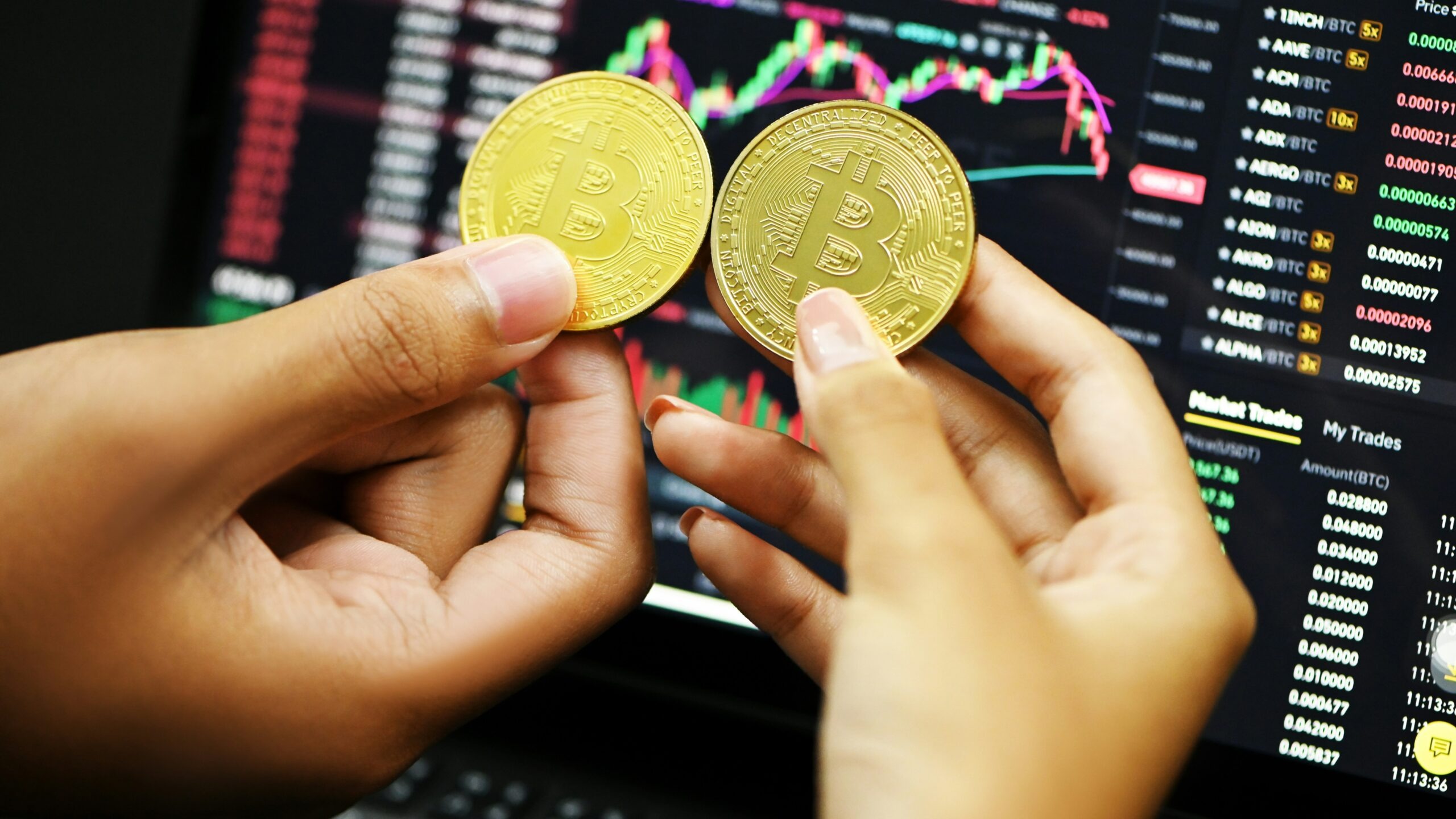 person holding gold round coin