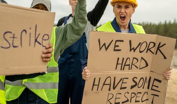 Crowd of dissatisfied builders standing for their rights on strike