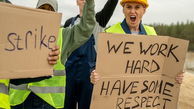 Crowd of dissatisfied builders standing for their rights on strike
