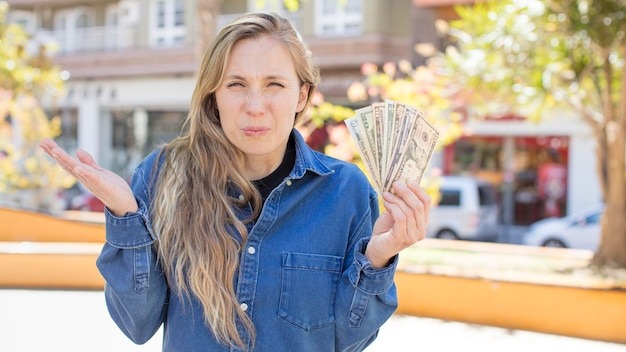 shrugging feeling confused and uncertain dollar banknotes concept