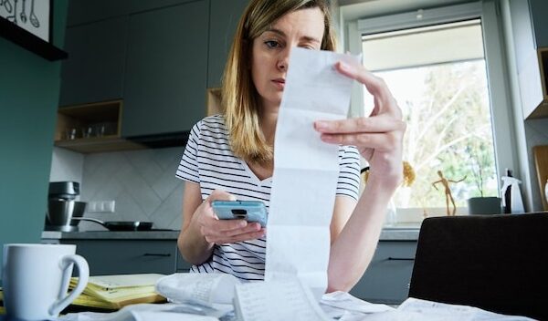 Woman calculating payment bill at home