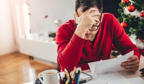 Man reading letter and holding hand at forehead
