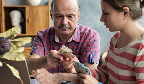 Olderly Spanish man gives his daughter money for a mortgage or student loan