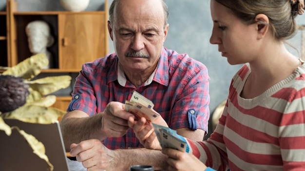 Olderly Spanish man gives his daughter money for a mortgage or student loan