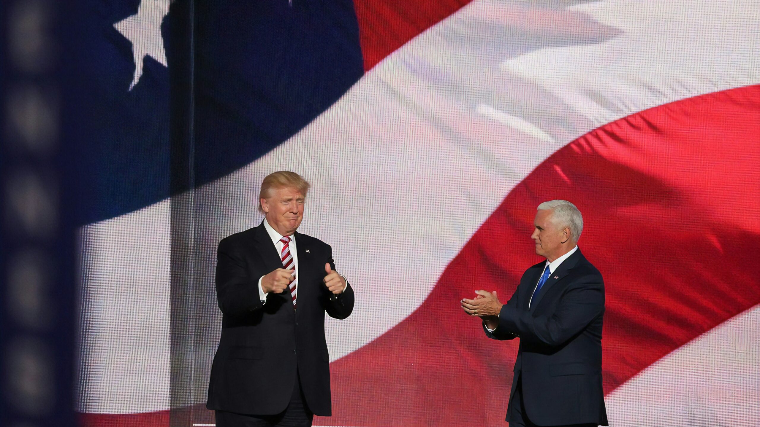 Donald Trump beside man in black suit
