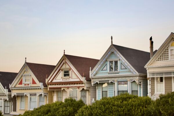 Colorful victorian houses stand in a row.