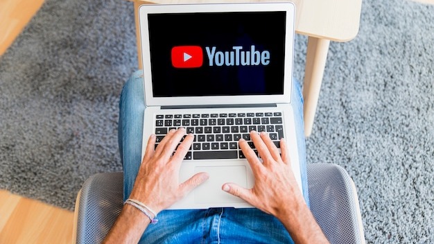 Guy sitting and watching at laptop