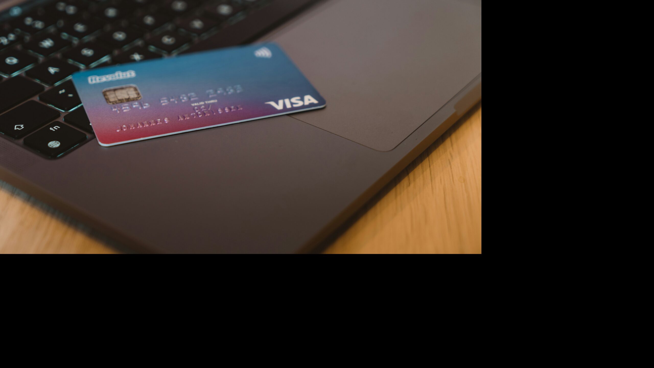 a person holding a credit card in their hand