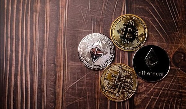 A beautiful silver ethereum and golden bitcoins digital crypto coin on wooden table with copy space