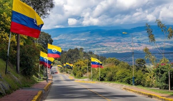 A scenic view of Bogota with Colombian flags flying with copy space