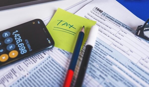 Tax form 1040 w9 pencil marker pen reading glasses and laptop are laying on accountants desk