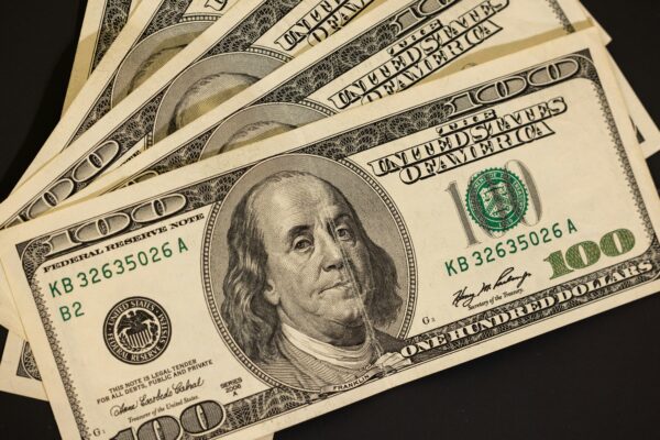 a stack of twenty dollar bills sitting on top of each other