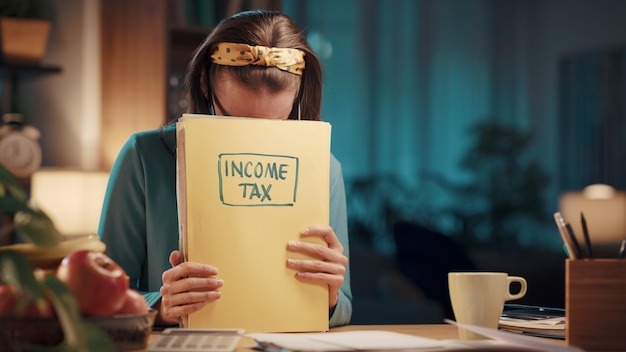 Frustrated woman checking tax documents at home