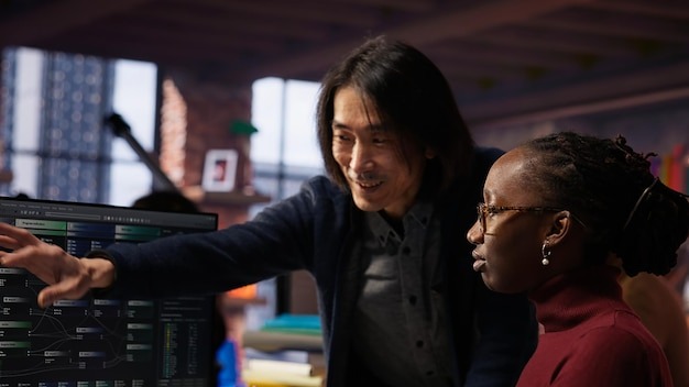 Senior team leader assisting worker in AI software development agency