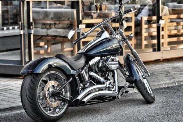 A sleek Harley-Davidson motorcycle parked on a city street, showcasing chrome detailing.