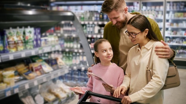 Shopping together family browsing in supermarket aisle