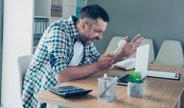 Employee with a blue checkered shirt working in the office